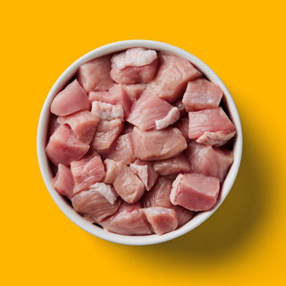 Just Raw Turkey 500g bowl against a yellow background, ideal for your dog's diet.