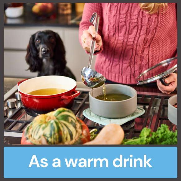 Person ladling Fish Bone Broth into a bowl on the stove, dog watching nearby. Text: "As a warm drink.