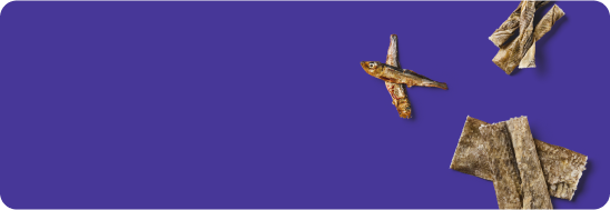 Dried fish and seaweed on a purple background with empty space on the left.