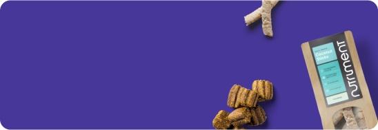 Dog treats and a Nutriment product package on a blue background.