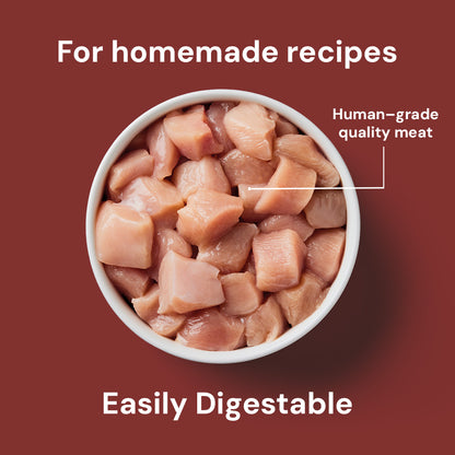 A bowl of Just Raw Chicken 500g labeled "Easily Digestible" for homemade recipes against a red background.