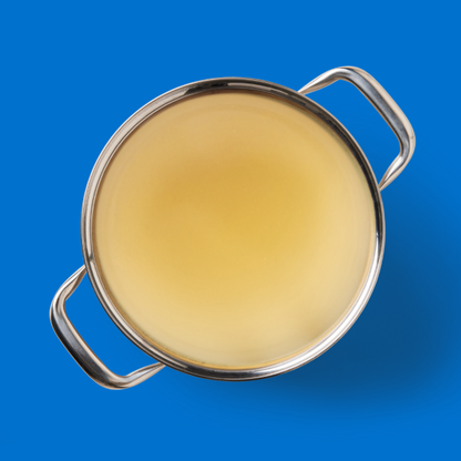 Top view of a stainless steel pot with Fish Bone Broth 500ml against a blue background.