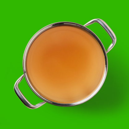 A pot of Lamb Bone Broth 500ml, viewed from above, on a bright green background.