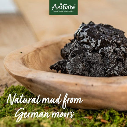 Aniforte Mineral Moor Mud 300g, labeled "Natural mud from German moors," in a wooden bowl on a rustic surface.