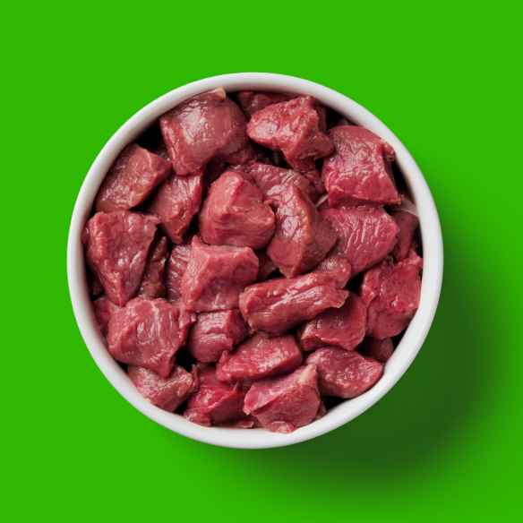 A Cat Raw Lamb 500g pack on a vibrant green surface.