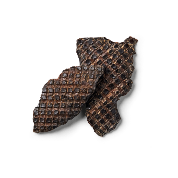 Dark chocolate wafers with a grid pattern overlap like Turkey Liver Chews on a white backdrop.